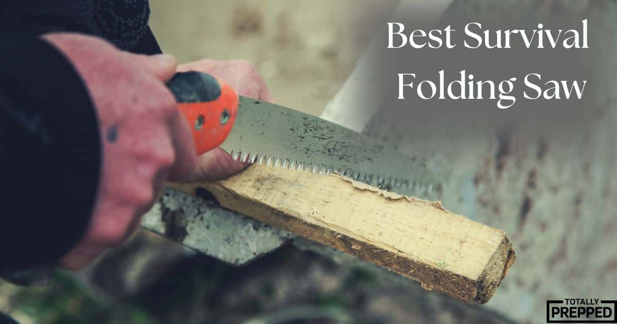 man using survival folding saw on piece of wood