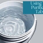 white bucket filled with water with title using water purification tablets